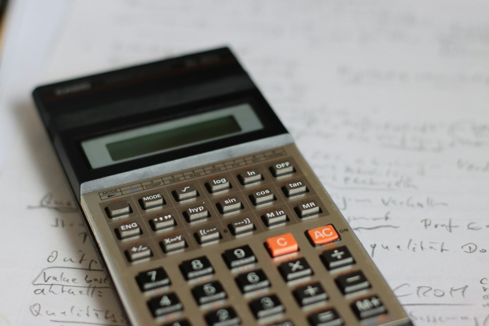 a calculator sitting on top of a piece of paper